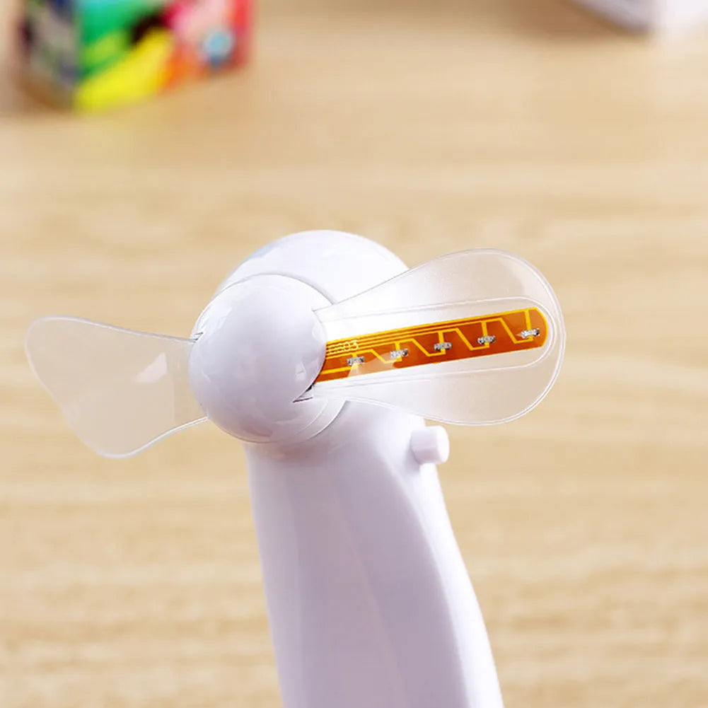 White handheld mini fan with LED flashing love pattern display