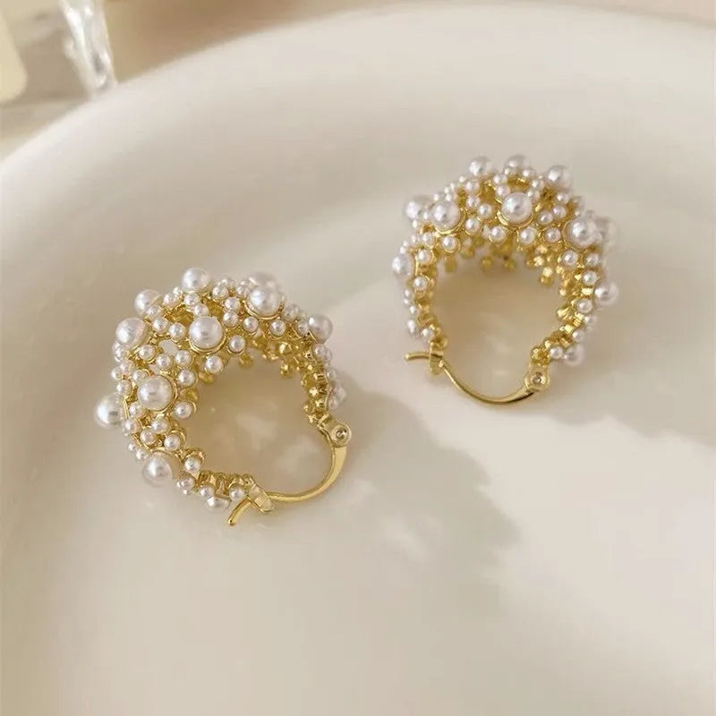 Gold-coloured copper basket flower earrings with pearl inlay and small rice-shaped bead detailing