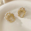 Gold-coloured copper basket flower earrings with pearl inlay and small rice-shaped bead detailing