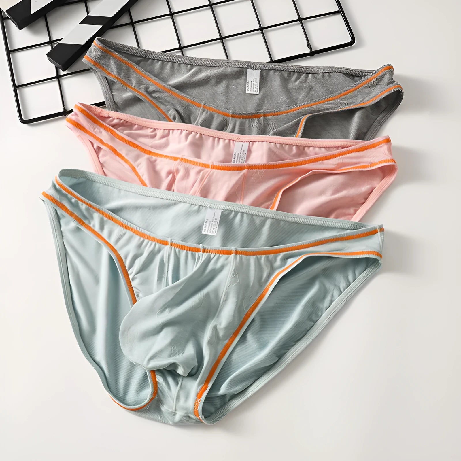 Men's knitted modal butt-lift hip underwear shown in one of five colour options: dark gray, pink, yellow green, colourful blue, or sky blue.