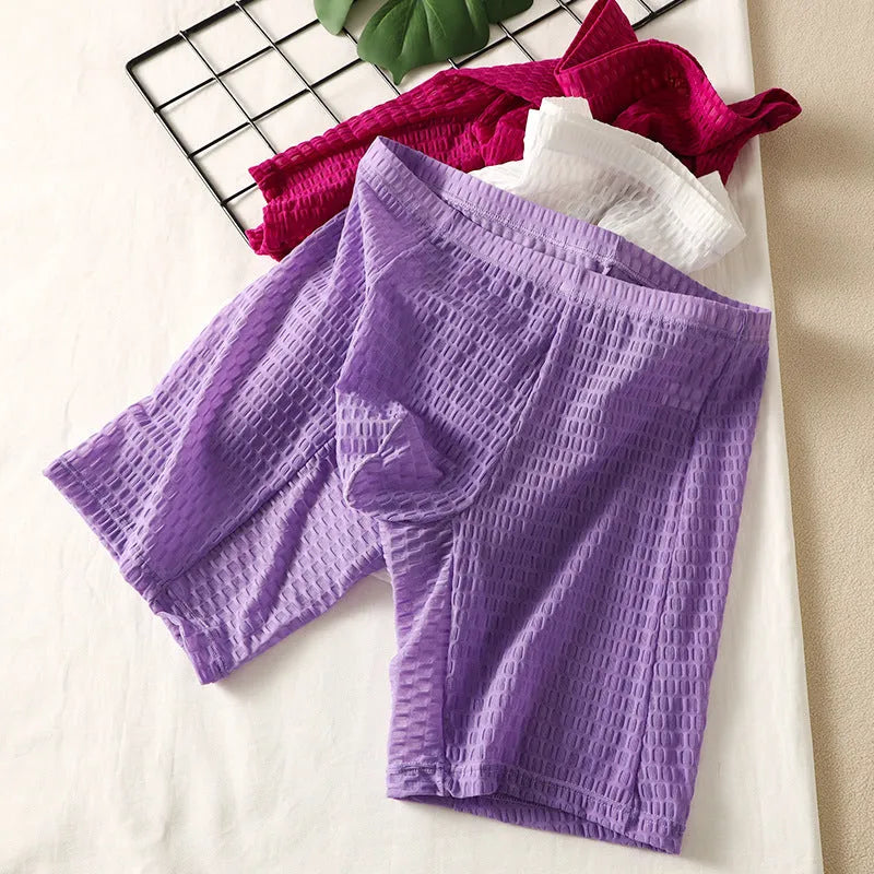 Men's lace boxer shorts in a lengthened hip lifting design, shown in one of five solid colours.