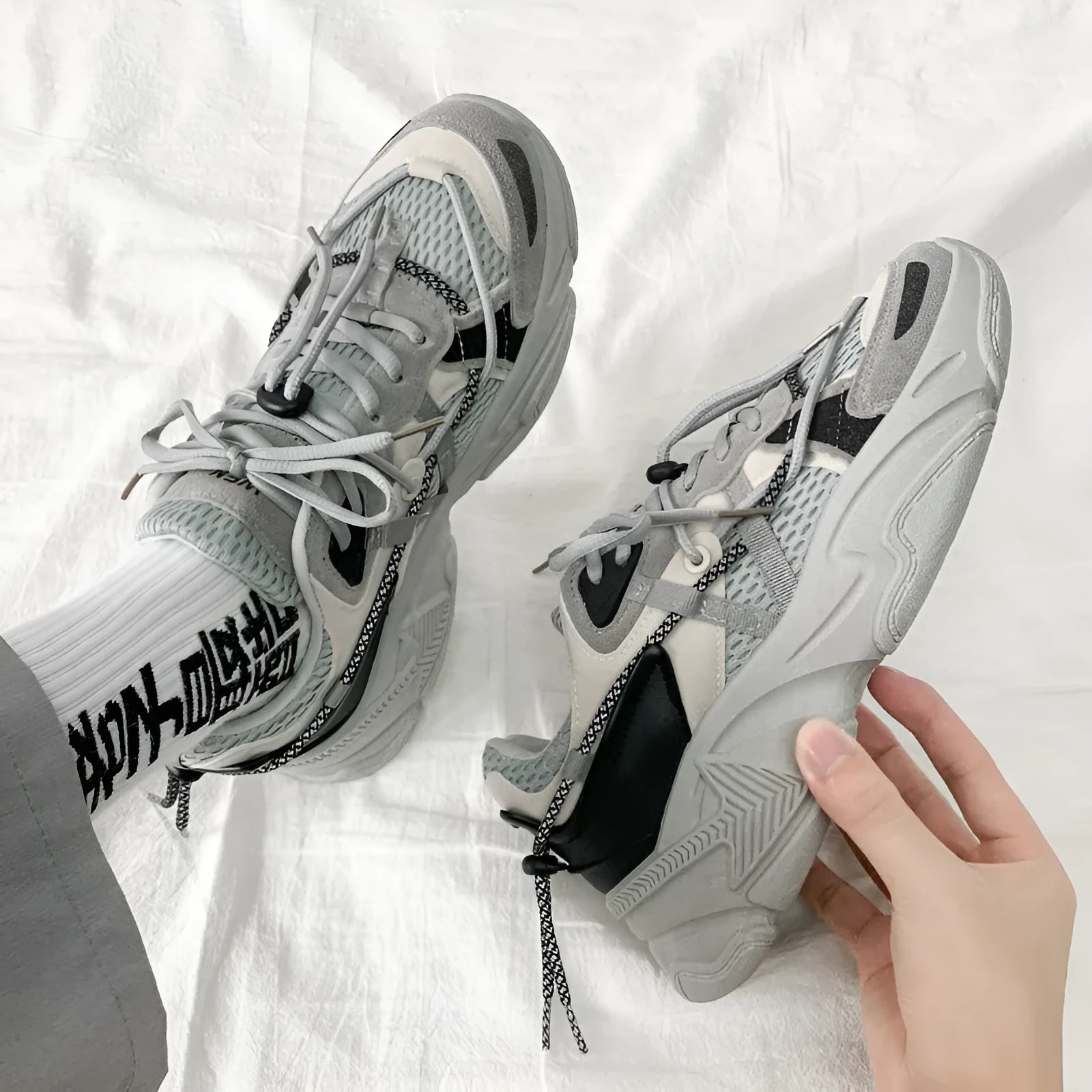 Men's Korean style platform dad sneakers in black, white, and grey colours with front lace-up closure