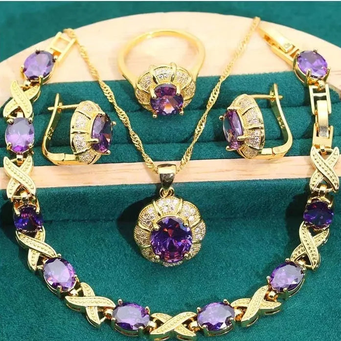 18k gold plated cubic zirconia jewellery set showing necklace, earrings, ring and bracelet in four colour options