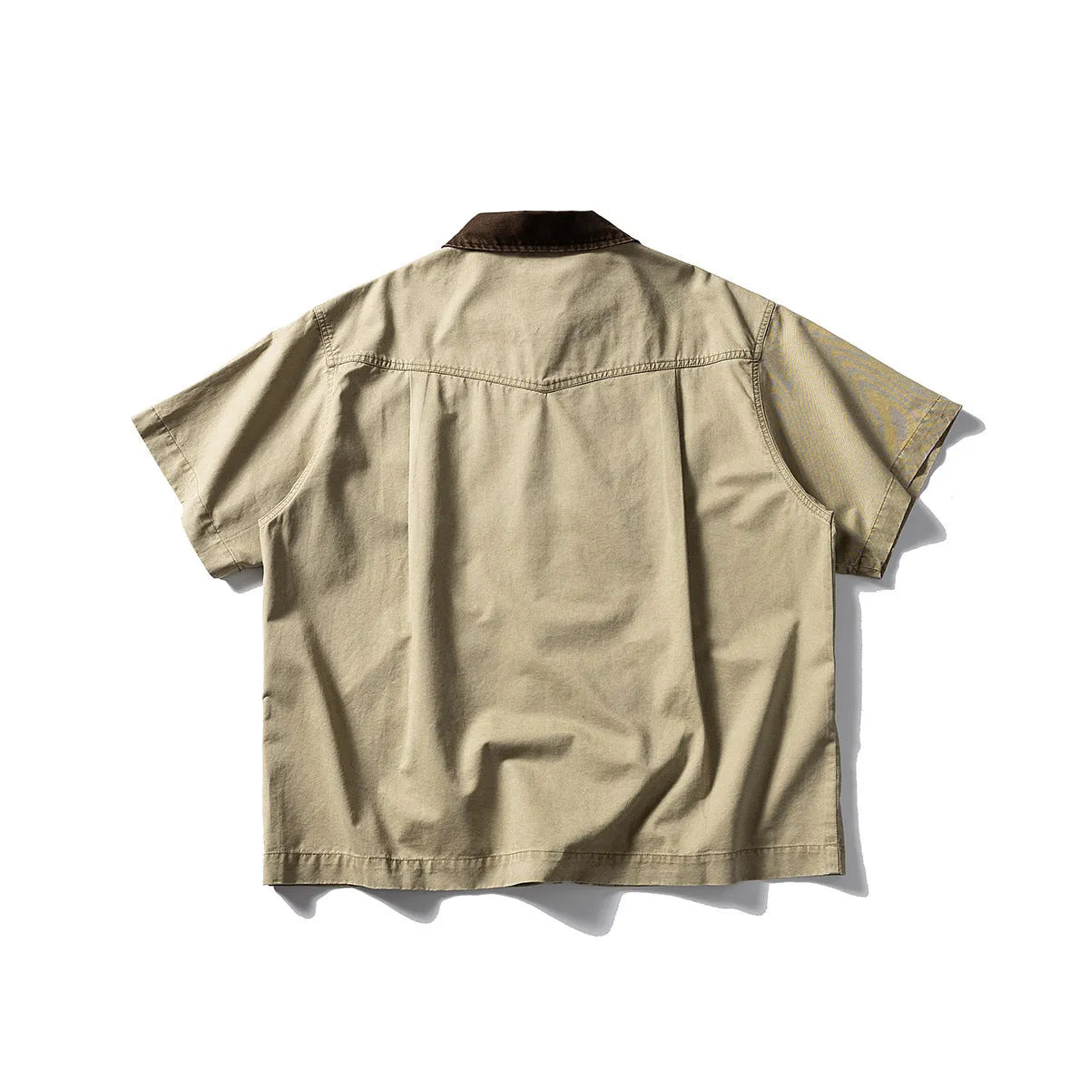 Teenager wearing a khaki loose-fit short sleeve cotton overalls shirt cardigan.