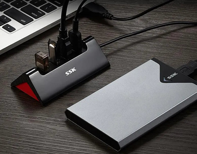 Black USB expansion dock with four USB ports and Micro USB power connection measuring 100mm x 50mm