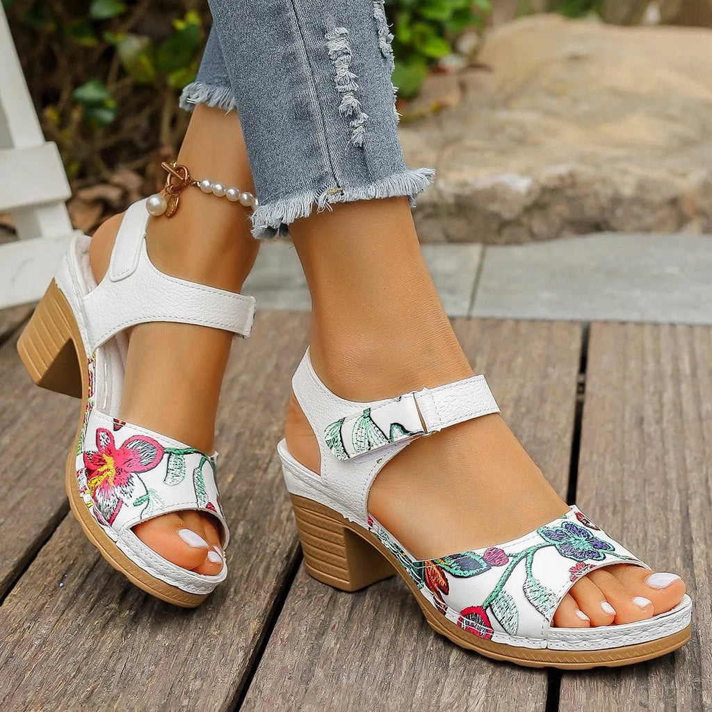 White women's casual high heel sandals with a Velcro strap buckle on a rubber sole.