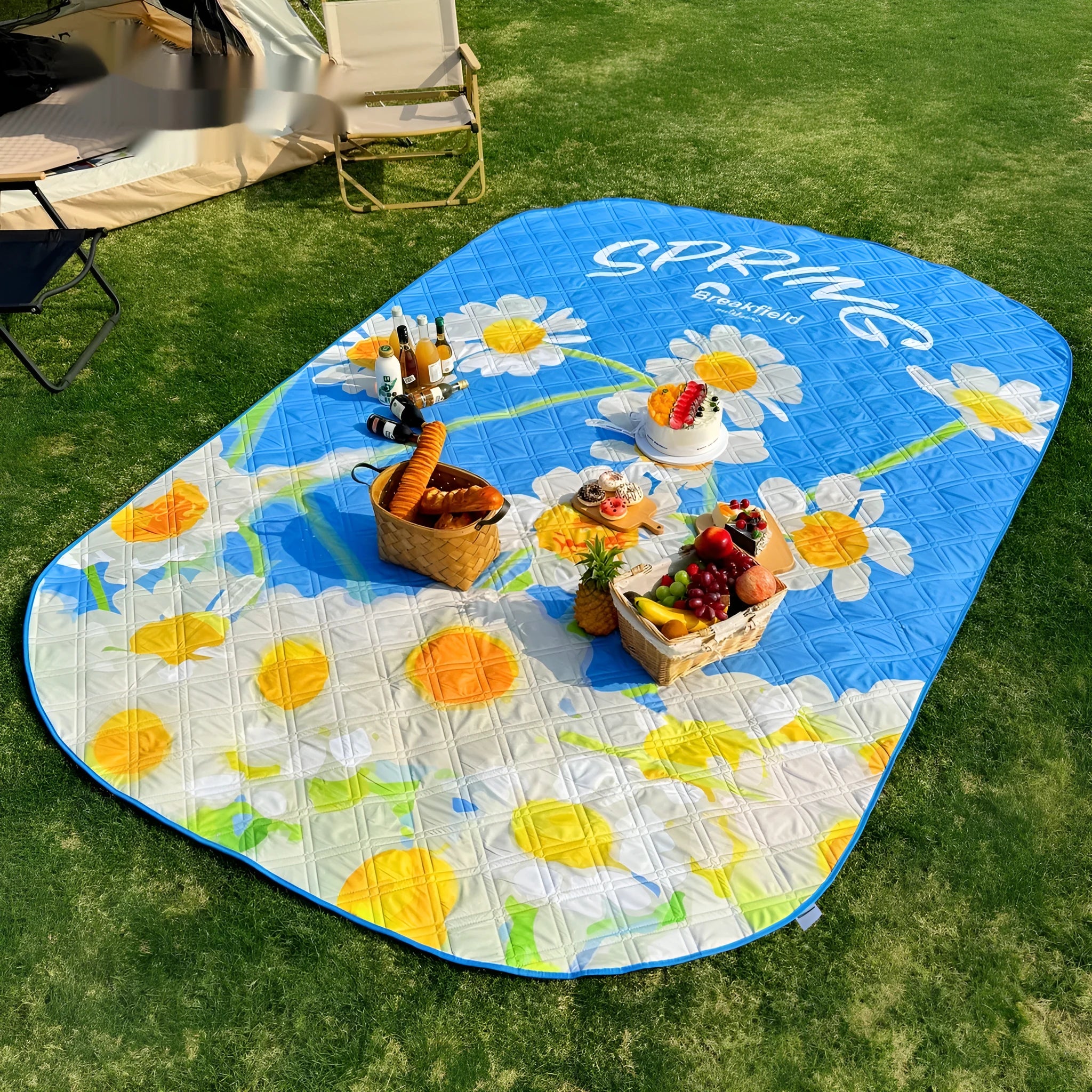 Waterproof ultrasonic thickening picnic mat in seasonal colour on grass, showing textured brushed fabric and moisture-proof backing