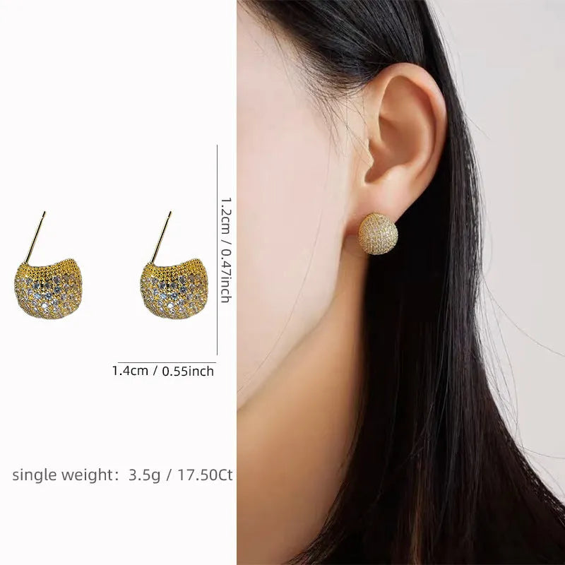 Gold and white geometric drop earrings with flashing lights and spherical elements