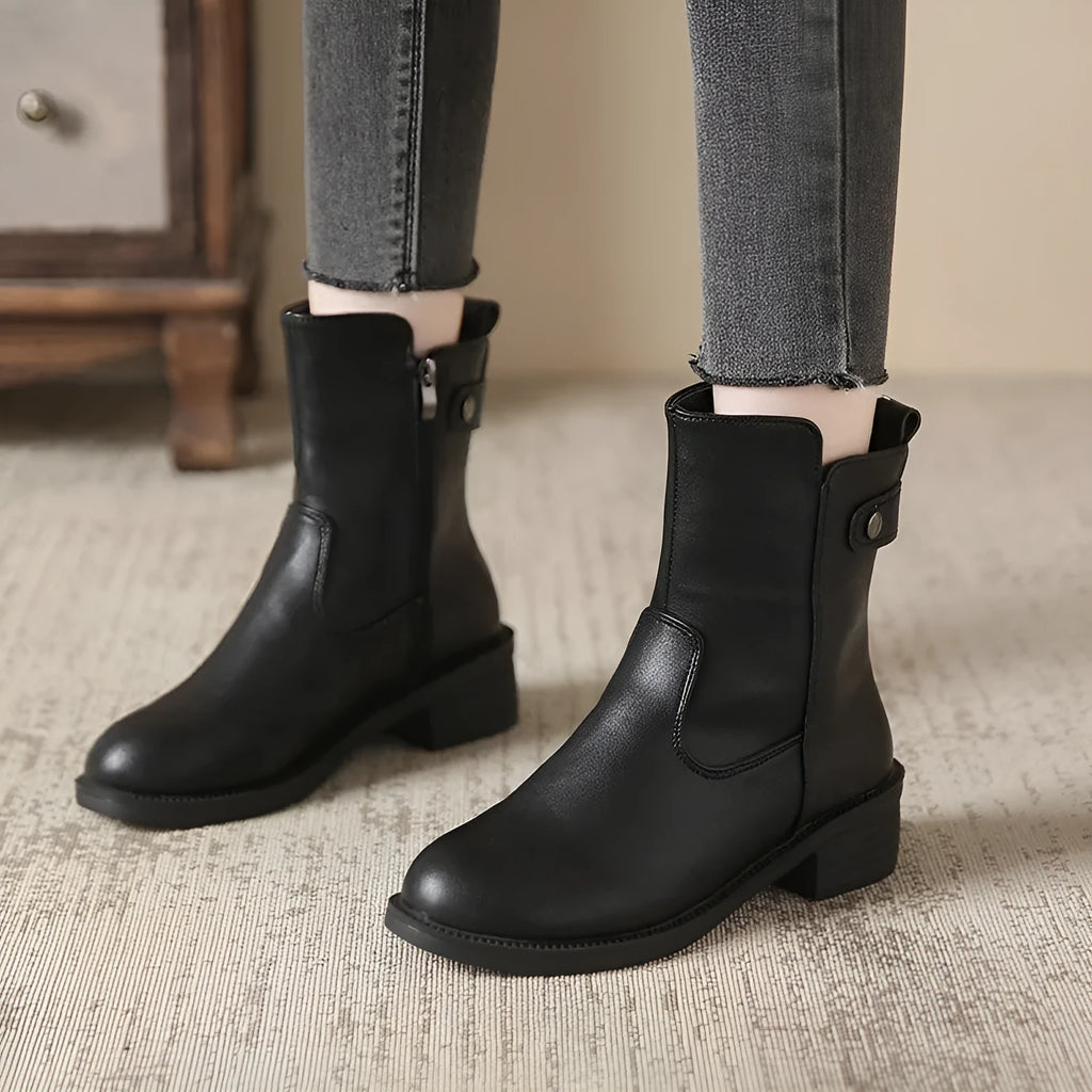 Black women's ankle boots with a side zip, round toe, and low rubber sole.