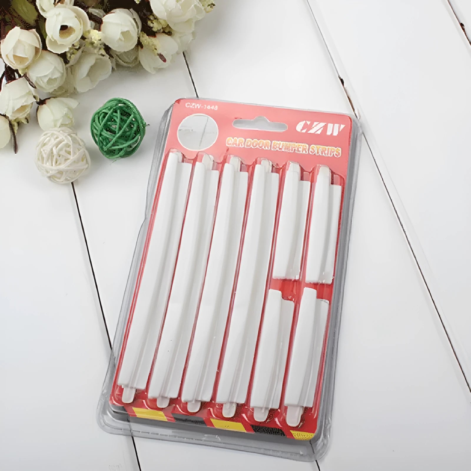 White plastic adhesive car door edge protection bumper strip roll.
