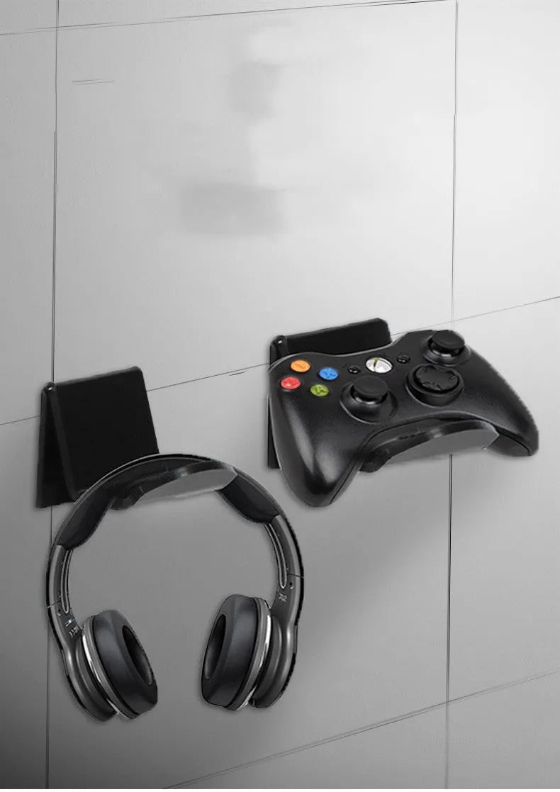 A universal plastic wall mount bracket for game controllers, shown in black colour