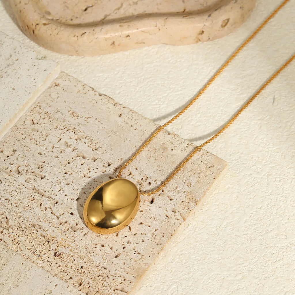 Geometric gold pendant on adjustable stainless steel chain necklace with regular links