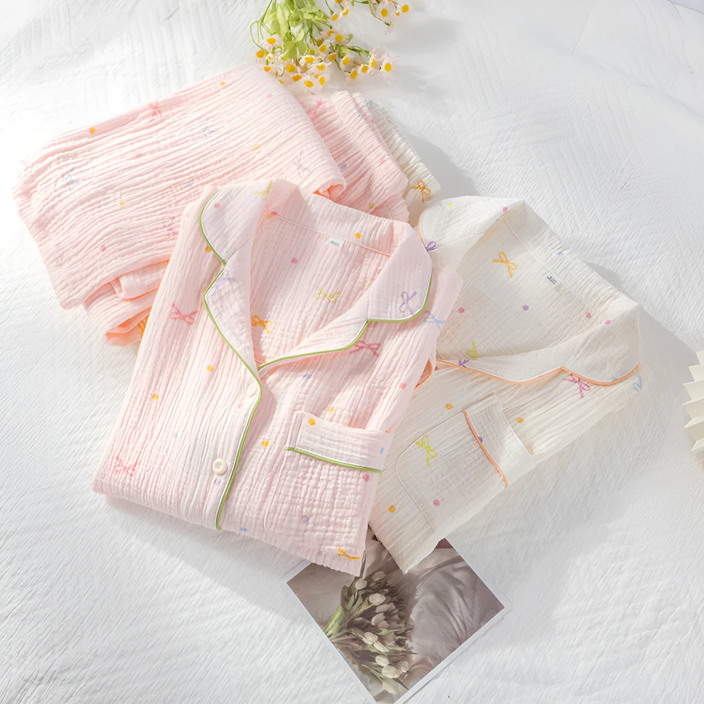 Women's long sleeve cotton pajama set in pink, featuring a top and trousers for sleepwear.
