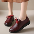 Women's black flat work shoes with round toe, front lacing, and soft anti-slip polyurethane sole
