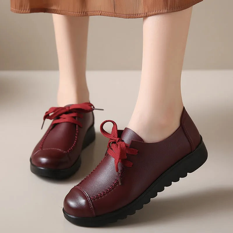 Women's black flat work shoes with round toe, front lacing, and soft anti-slip polyurethane sole