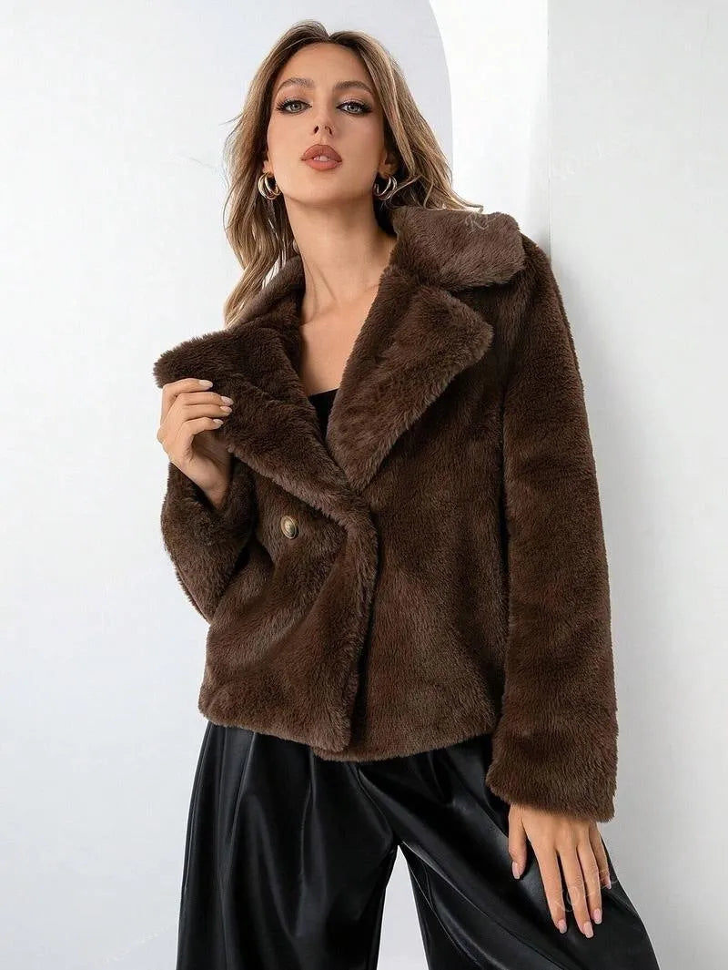 Women's loose-fitting short faux fur coat in rose red colour on a hanger.