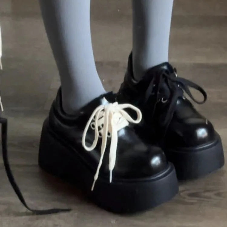 Women's matte black retro lace-up shoes with thick rubber sole and block heel.