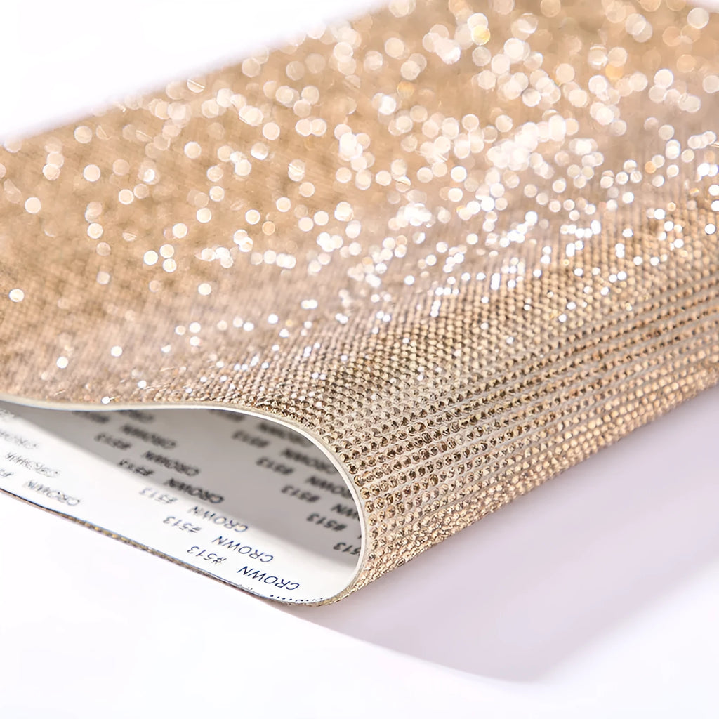 Sheet of rhinestones in an eight-eye pattern on a glue net backing, showing multiple colour options.