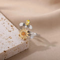 Gold and platinum adjustable open-mouth decompression ring with rotatable geometric component.