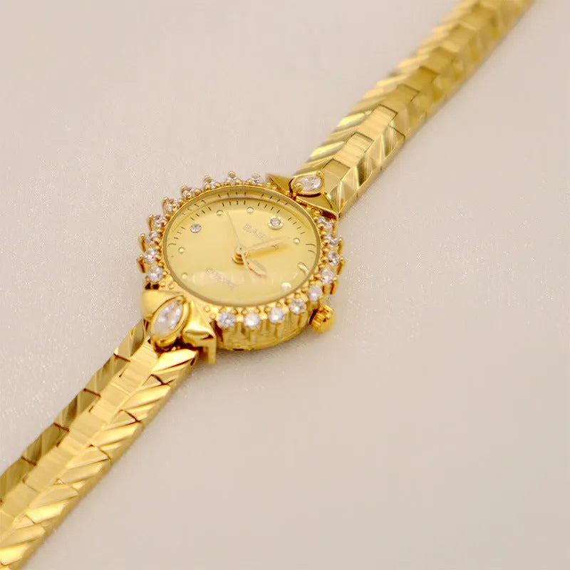 Women's vintage quartz watch with gold face and diamond embossed bracelet, slim 6mm design on a neutral background