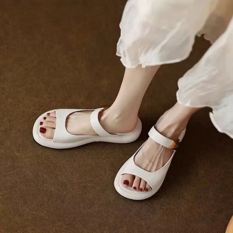 Women's apricot peep toe flat platform sandals with a leather upper and rubber sole.