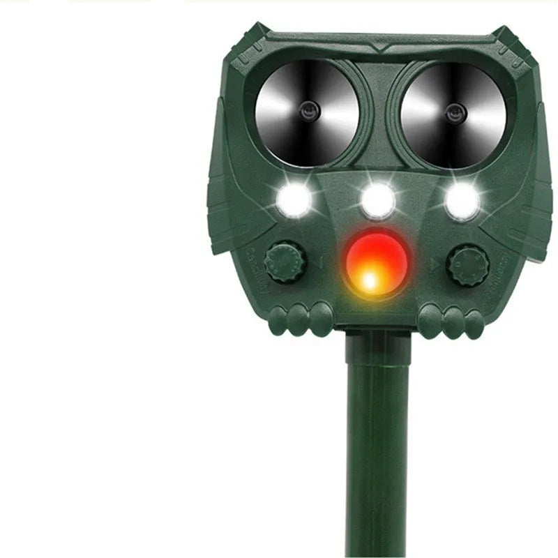 Green solar-powered ultrasonic animal repeller unit for outdoor pest control.