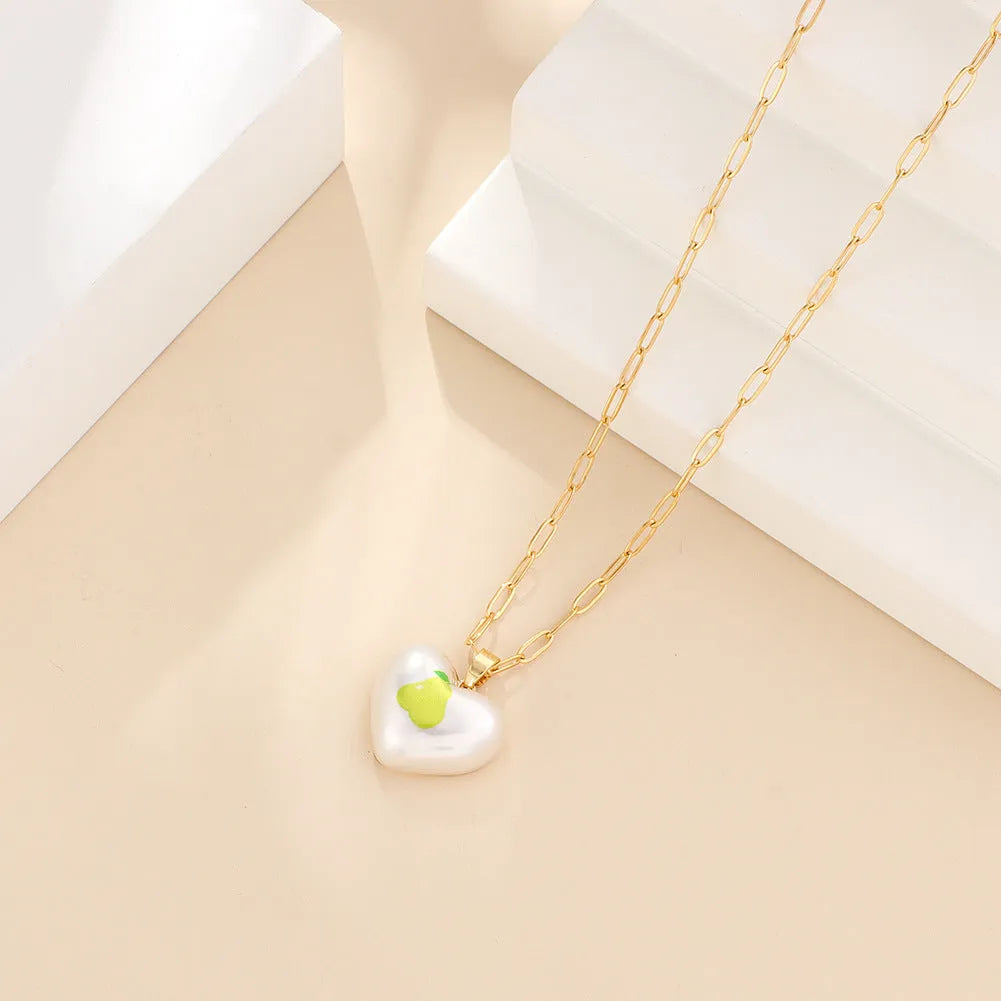 Adjustable chain necklace with a choice of geometric fruit pendant charms: apple, cherry, pear, pineapple, or strawberry.