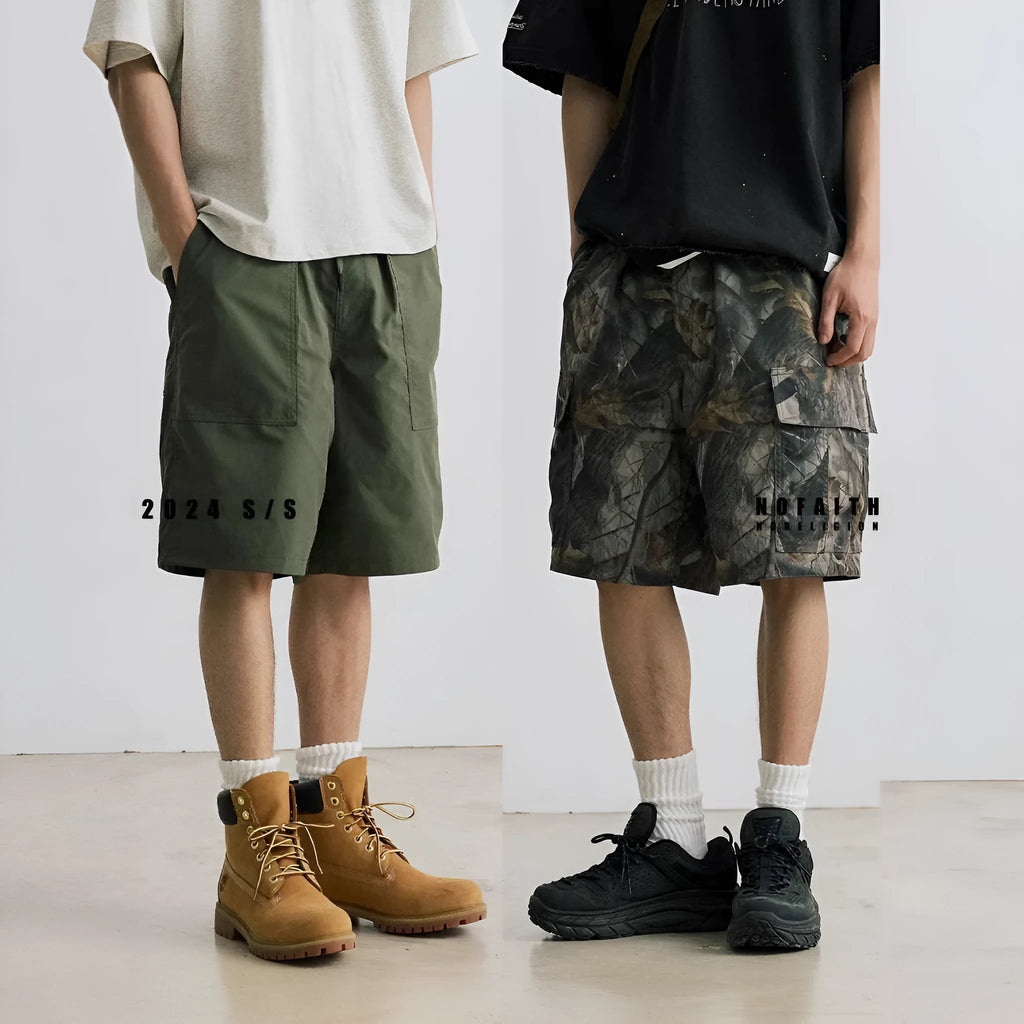 Loose fit straight-leg denim shorts on hanger, showing micro-elastic waistband and zip fly in army green colour.