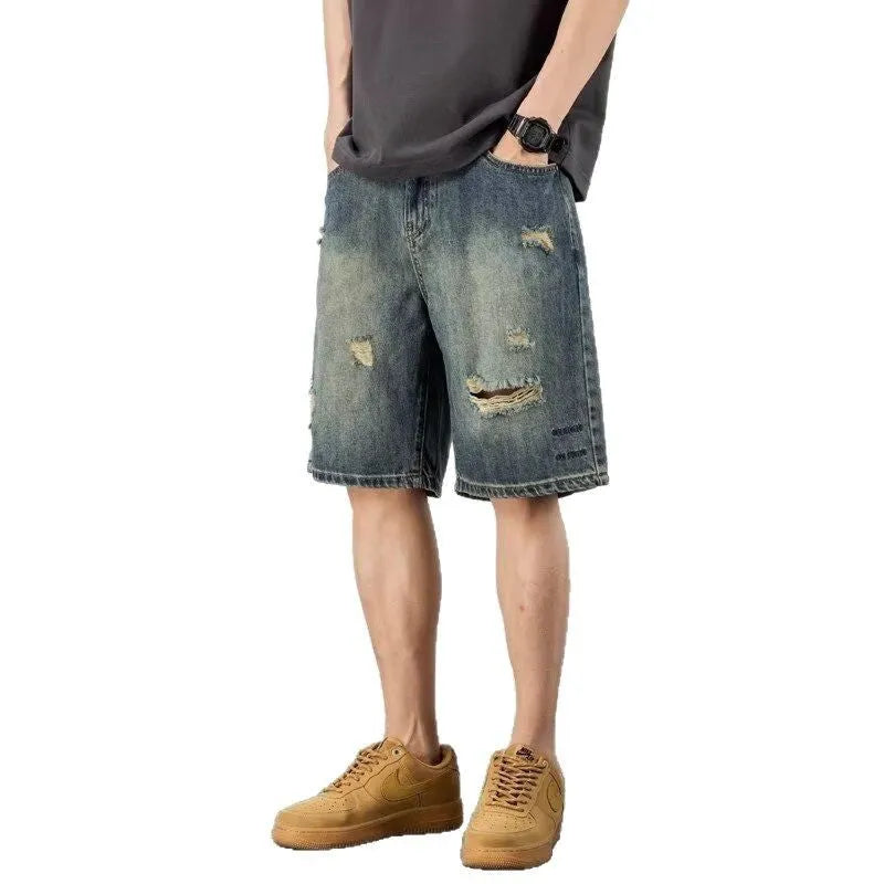 Men's blue retro loose hole denim shorts with a straight leg cut on a neutral background.