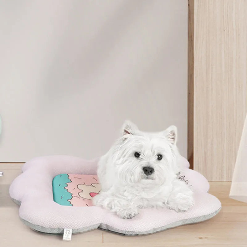 Green pet cooling mat for dogs and cats on a wooden floor.