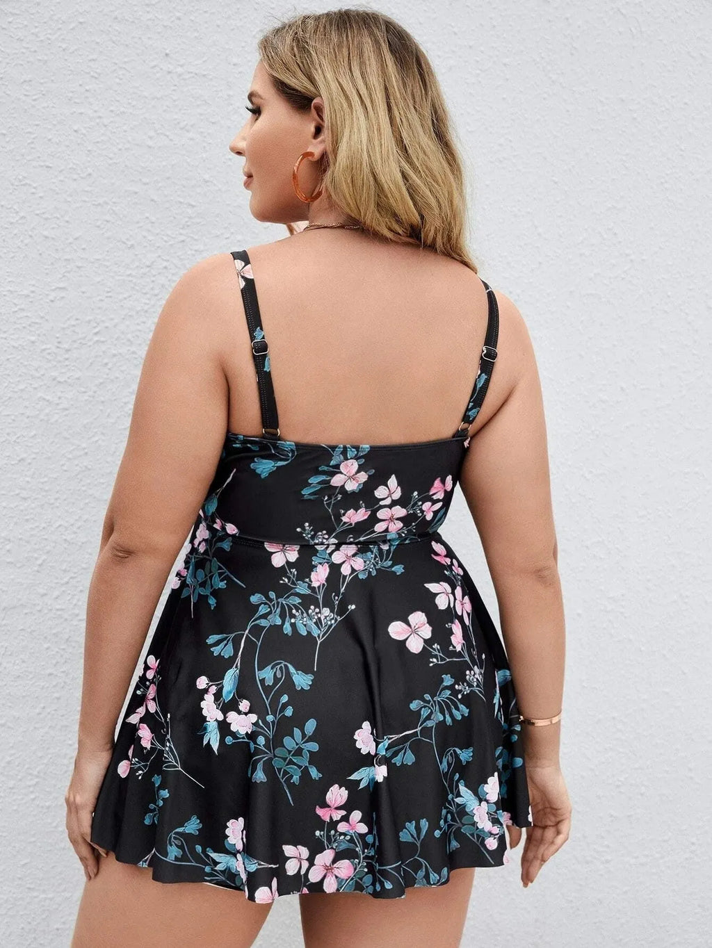 Women's one-piece floral print swimsuit in split colours on a mannequin, showing front design.