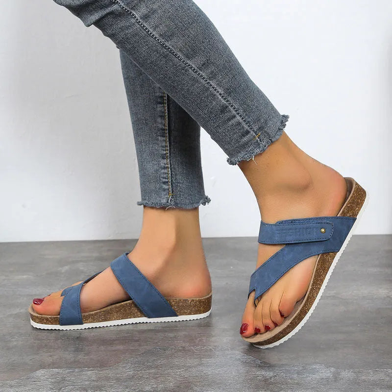 Solid colour thick-soled flat toe ring flip-flops on a white background.