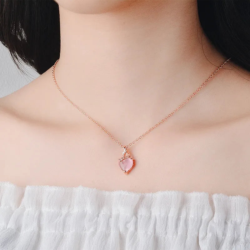 Women's heart-shaped pink synthetic crystal pendant necklace on rose gold cross chain