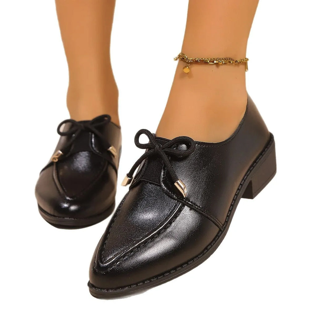 Women's British-style flat shoes with decorative bow, PU upper, and rubber sole in sizes 36-43.