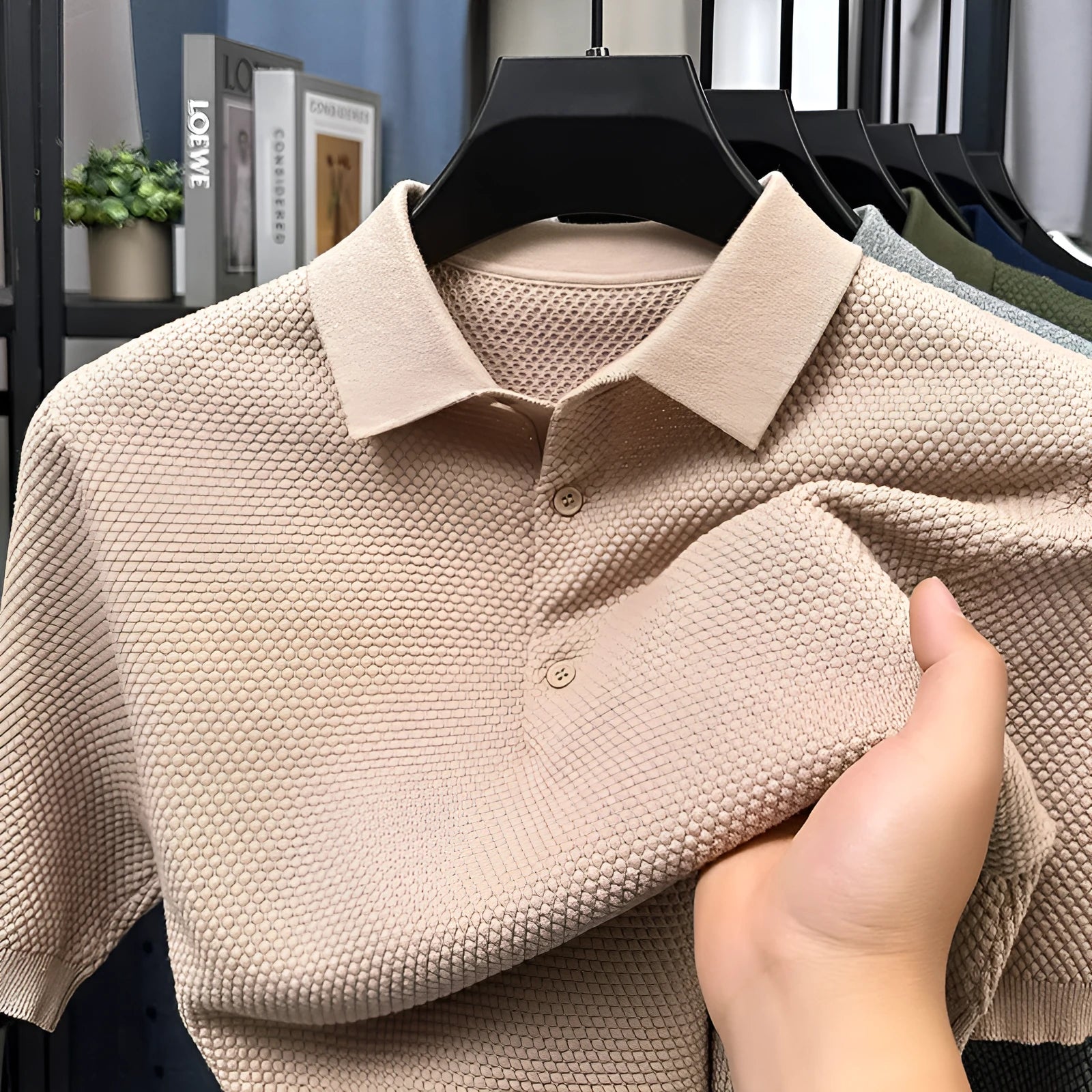 Loose-fitting short sleeve cotton pullover sweater in a neutral colour on a hanger.