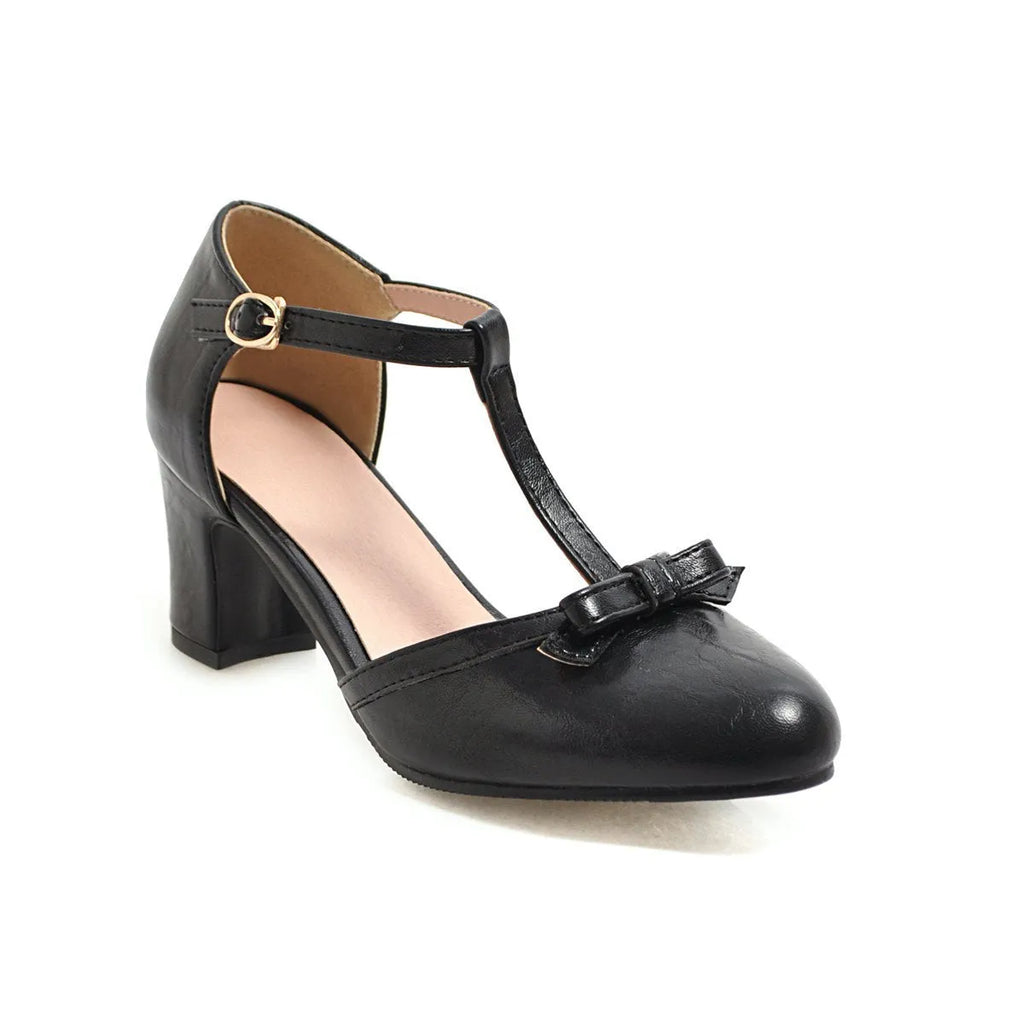 Women's apricot chunky heel sandals with a bow detail and hollow-out sides on a white background.