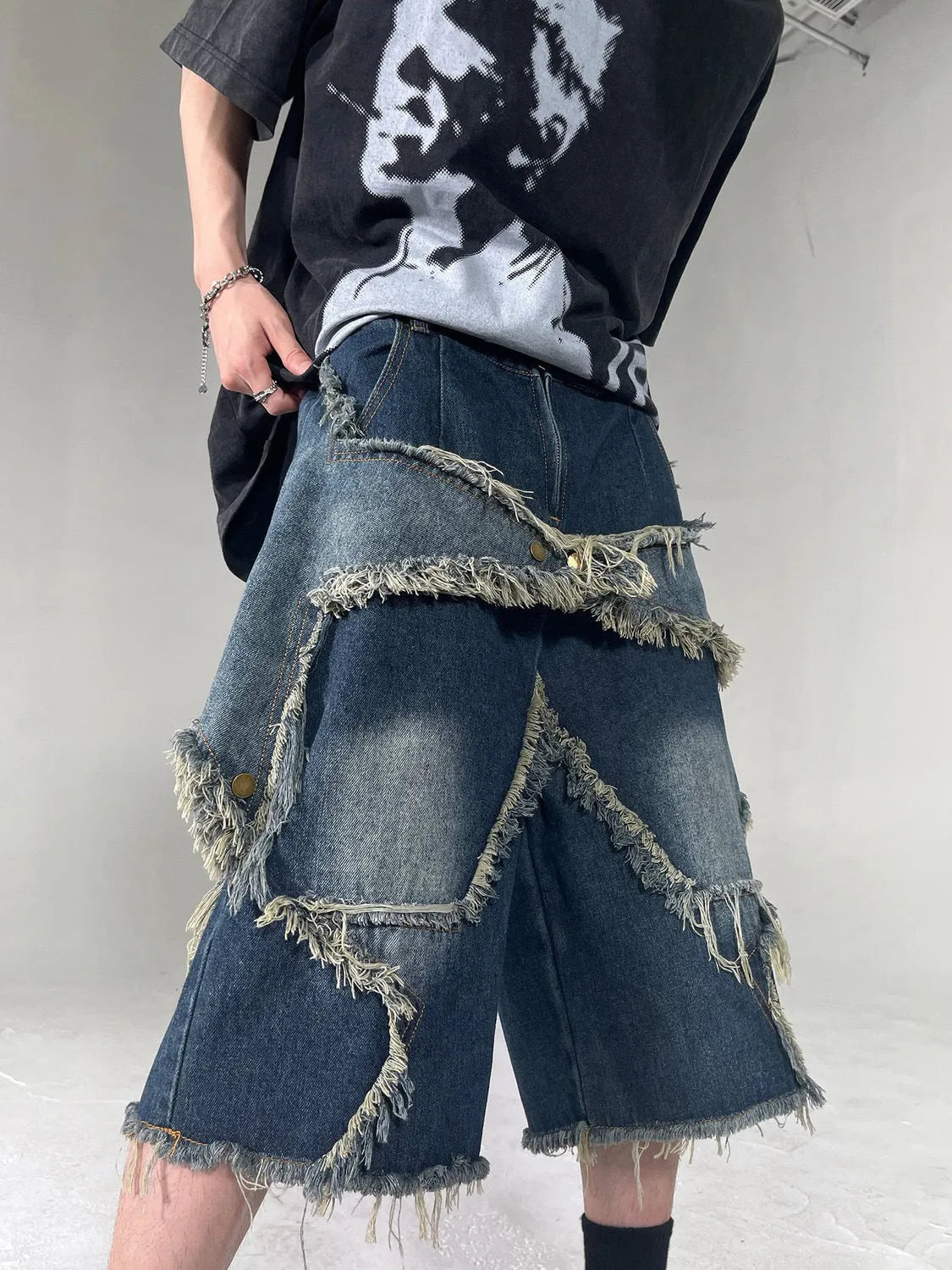 Men's blue retro denim shorts with frayed hem and five-pointed star design, loose fit with knee-length styling