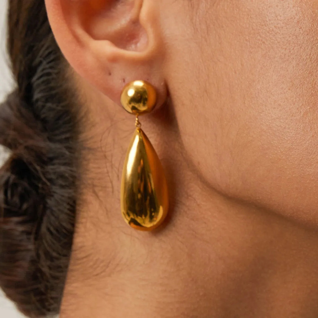 Gold electroplated stainless steel earrings with geometric water droplet hemisphere pendant design