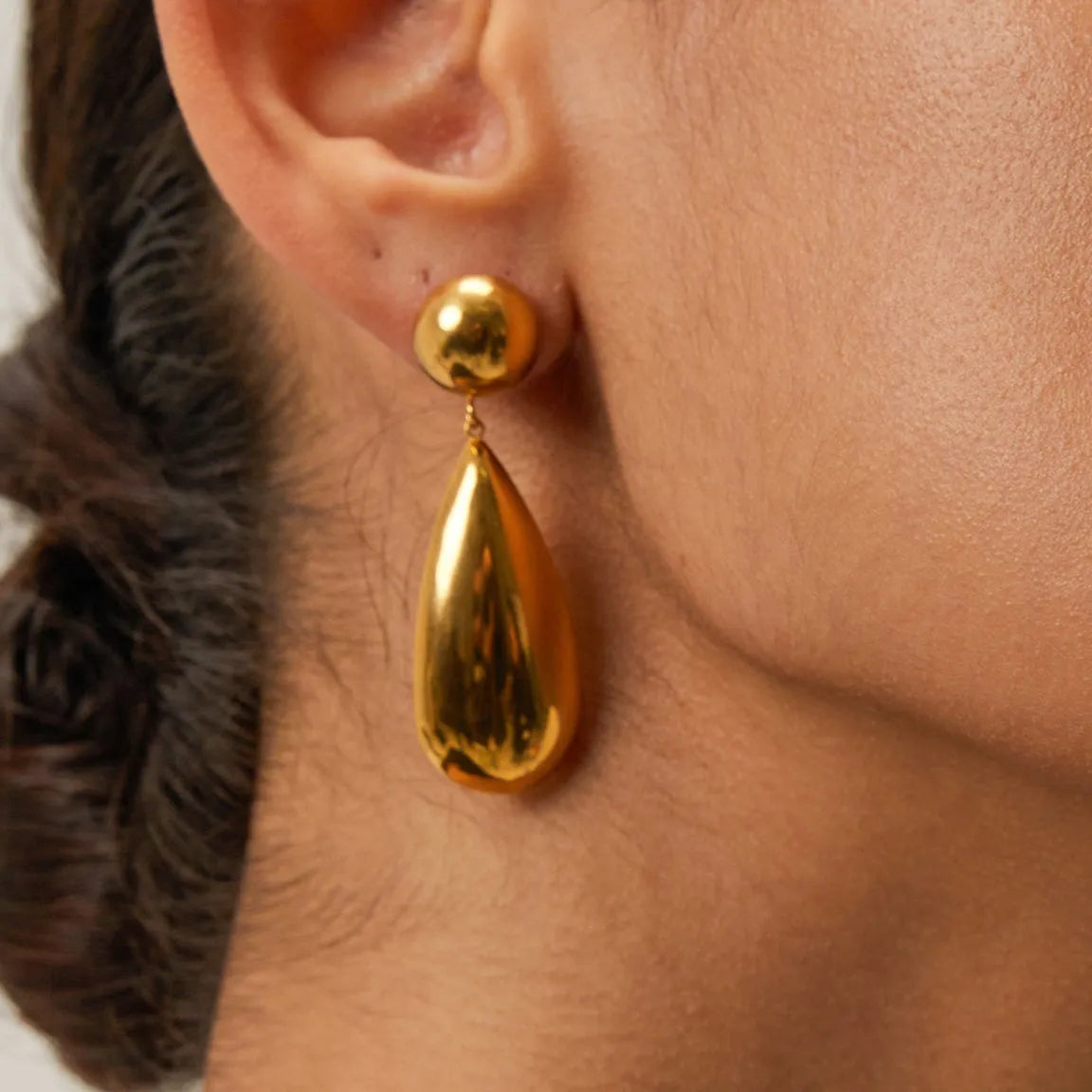 Gold electroplated stainless steel earrings with geometric water droplet hemisphere pendant design