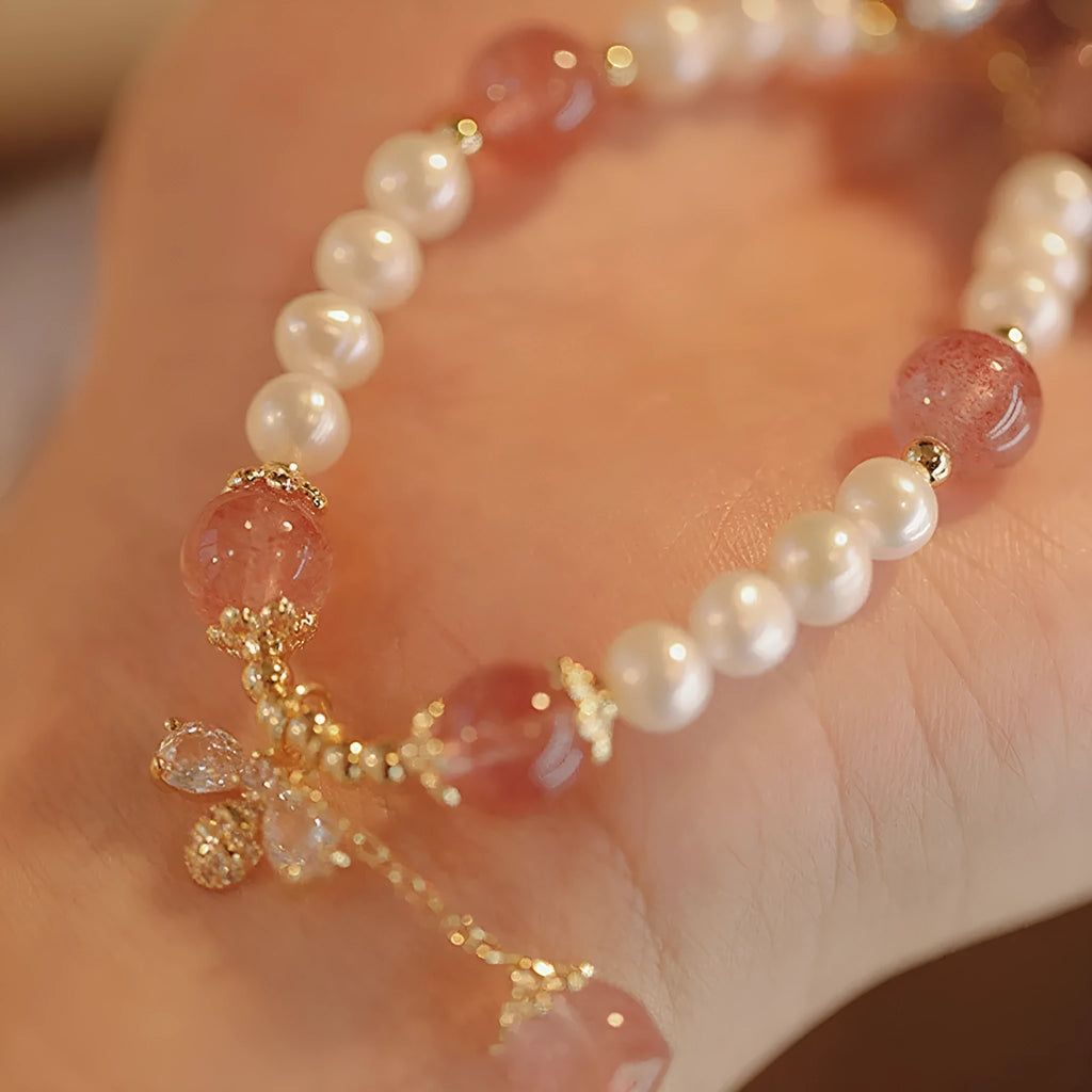 Strawberry quartz colour crystal bracelet with bow and stringed pearls.
