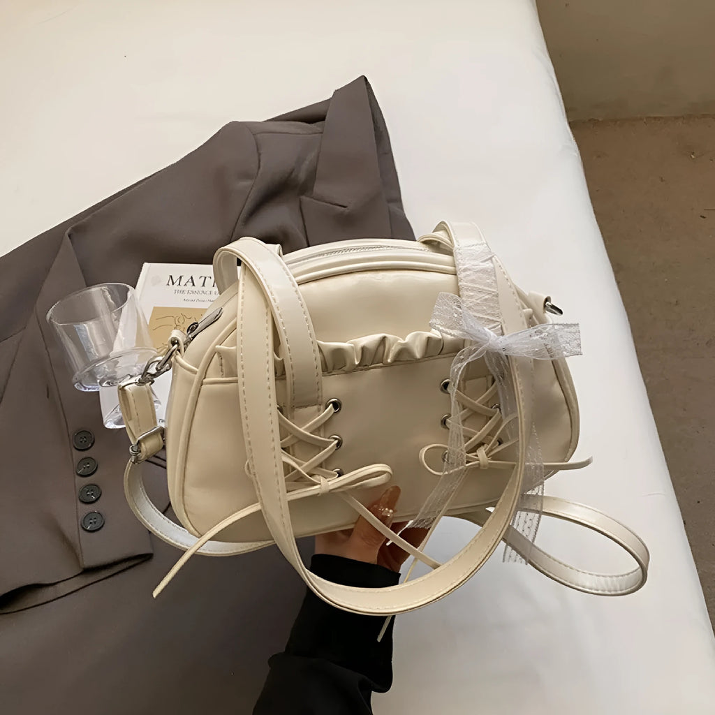 Women's casual shoulder handbag with bandage bow detail in PU material showing internal phone compartment