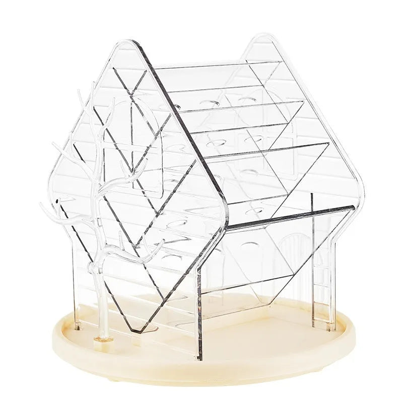 Rotating clear plastic cosmetic storage box organiser on a table.