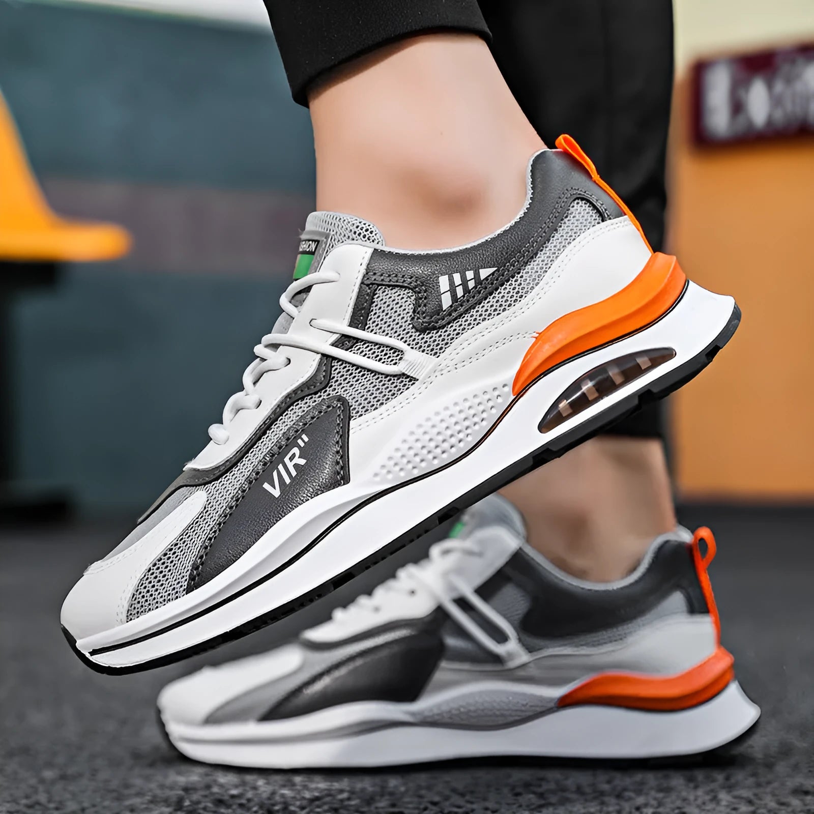 Men's gray mesh running shoes with round toe and visible stitching, shown from side view
