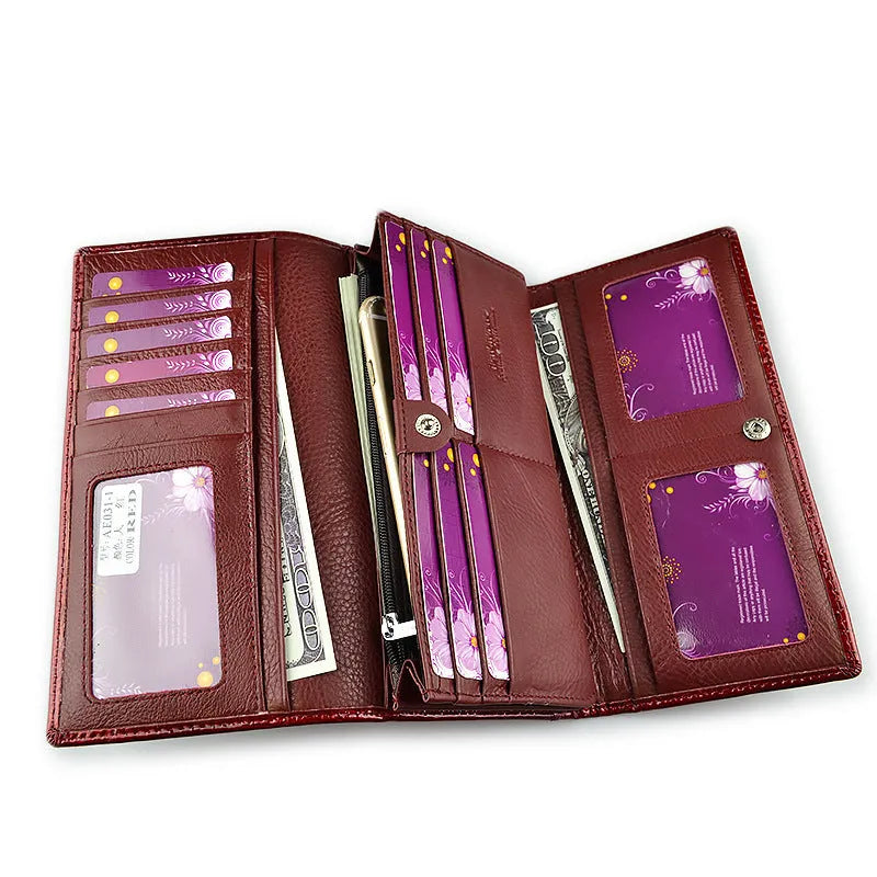 Women's patent leather purse with crocodile pattern in red colour showing pigskin lining interior