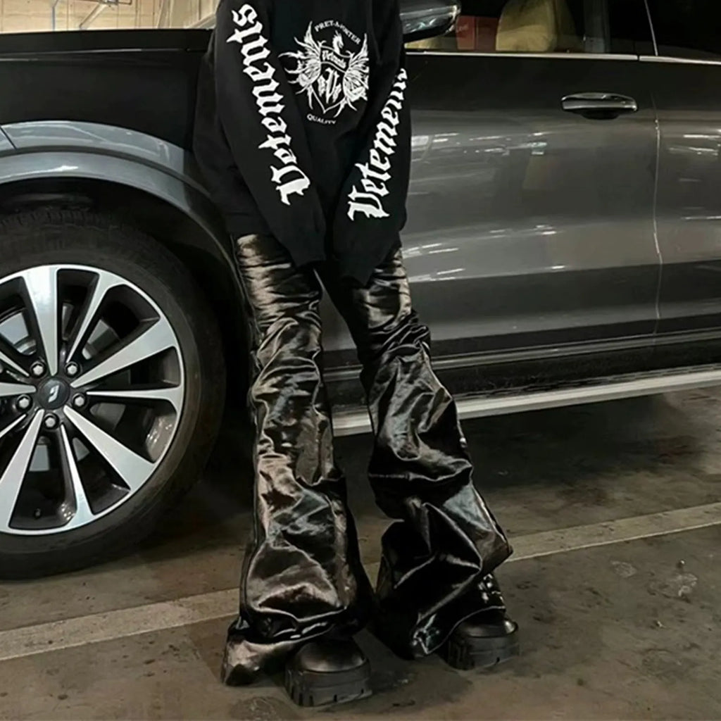 Black patent leather coated skinny jeans with straight leg silhouette and mid waist design