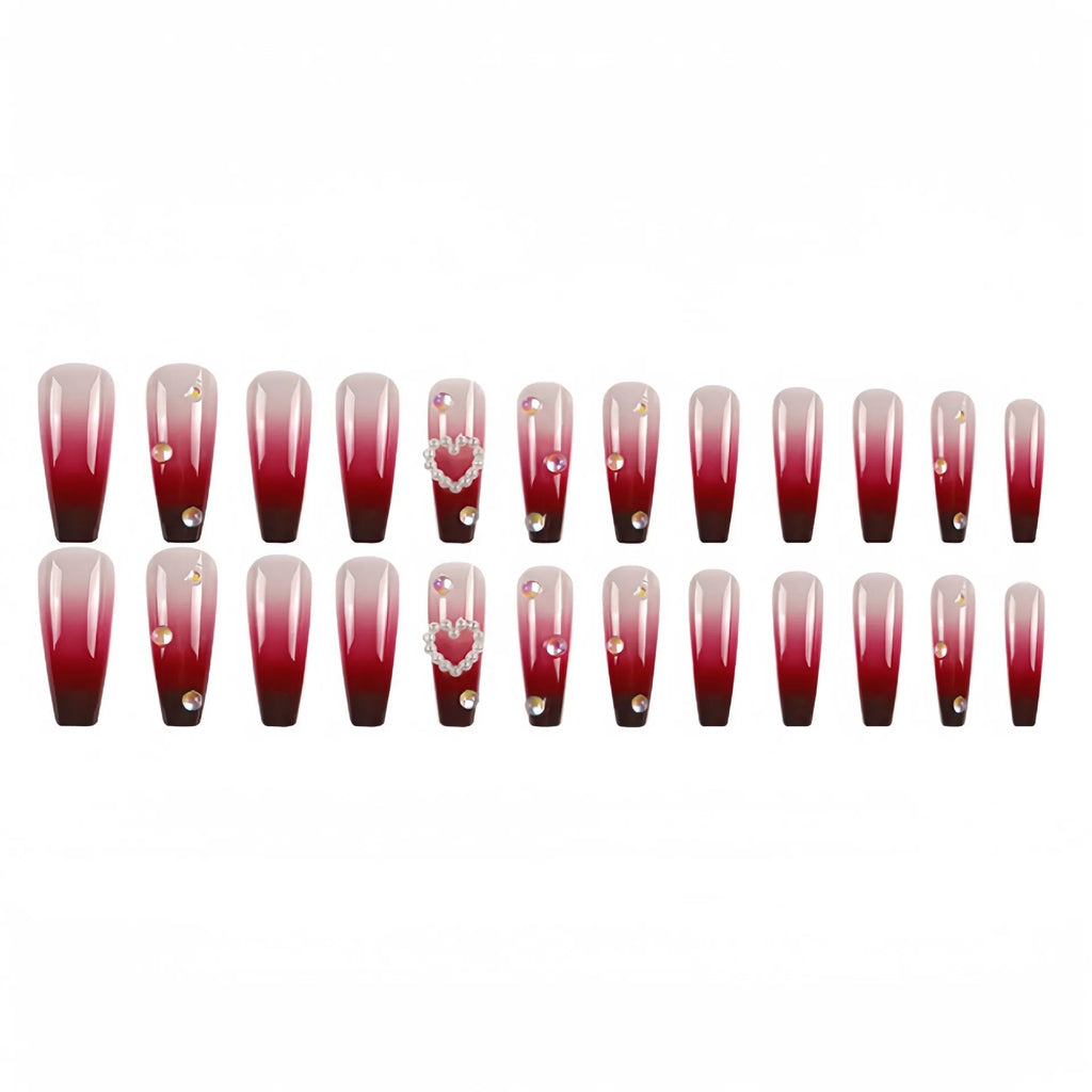 Set of long wine red gradient fake nail tips with pearl and heart design on a plaid pattern, shown with jelly glue and rubbing clause.