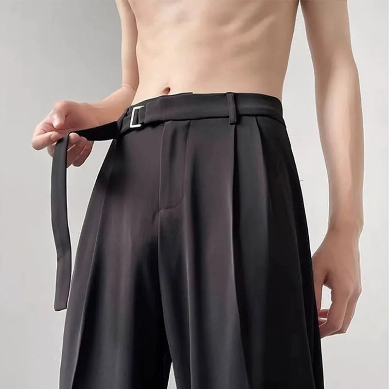 Man wearing thin straight-cut wide leg casual trousers in black, showcasing the loose fit and straight leg opening.