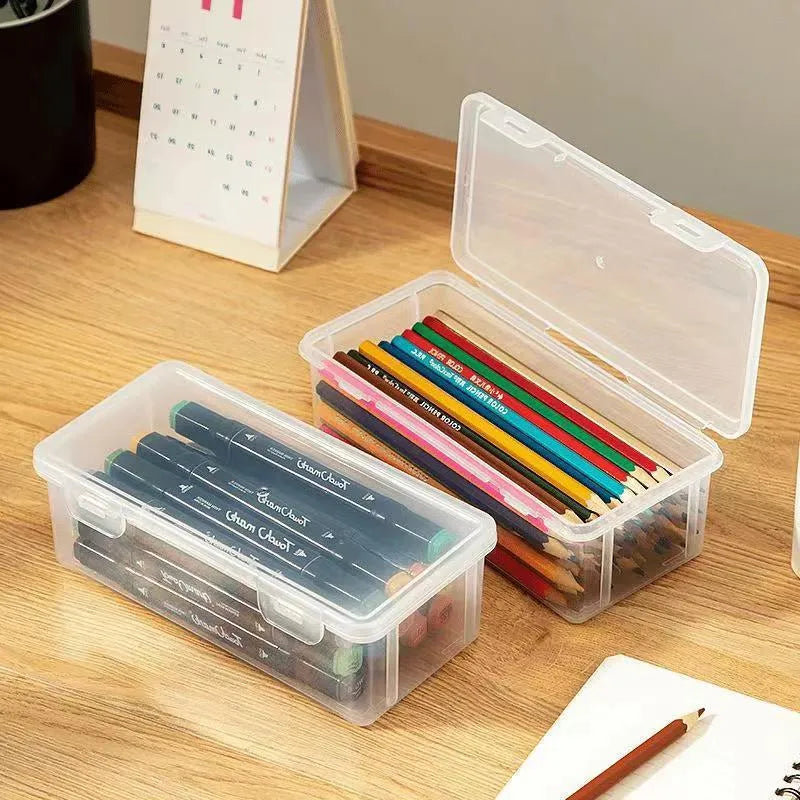 Transparent plastic pencil storage box full of coloured pencils and crayons