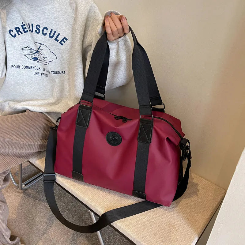 Waterproof Oxford cloth travel bag in solid colour with breathable back panel and 36-55L capacity