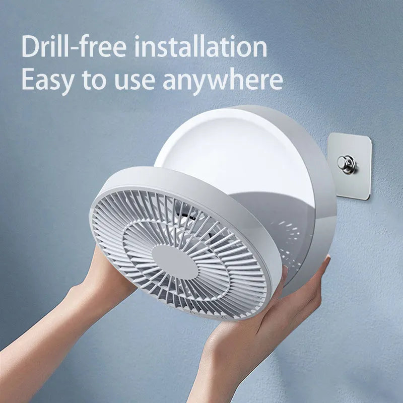 White portable rechargeable folding fan with night light and remote control on a desk